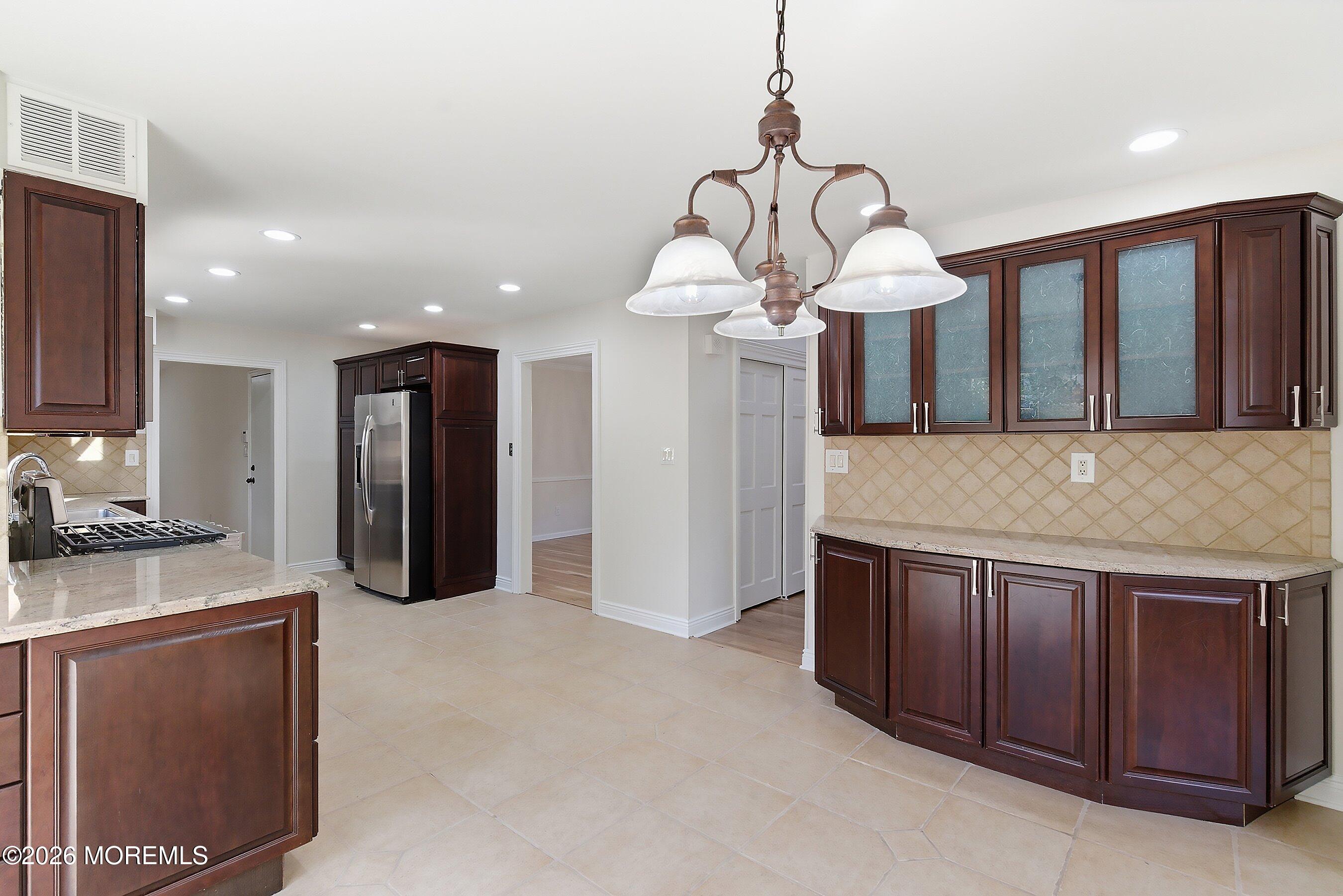 7 Shire Way Middletown, NJ 07748 - Photo 20 of 61 a kitchen with stainless steel appliances granite countertop a refrigerator a sink dishwasher a oven and a dining table with wooden floor