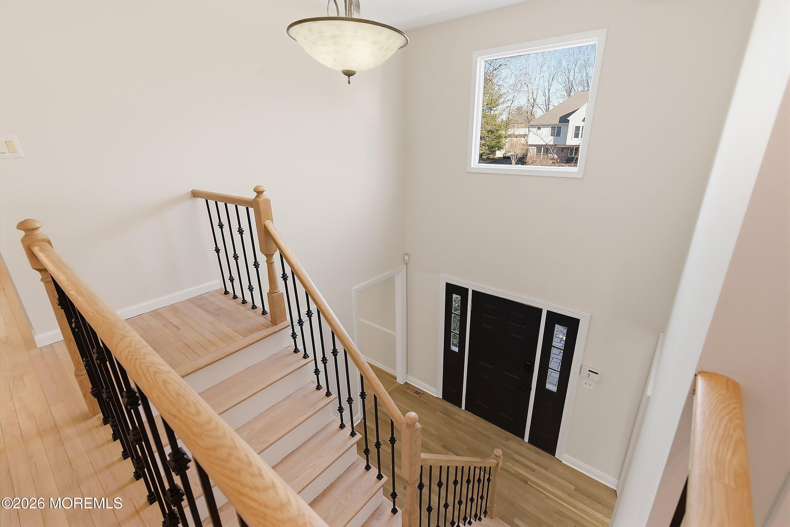7 Shire Way Middletown, NJ 07748 - Photo 26 of 61 a view of a hallway with wooden floor and stairs
