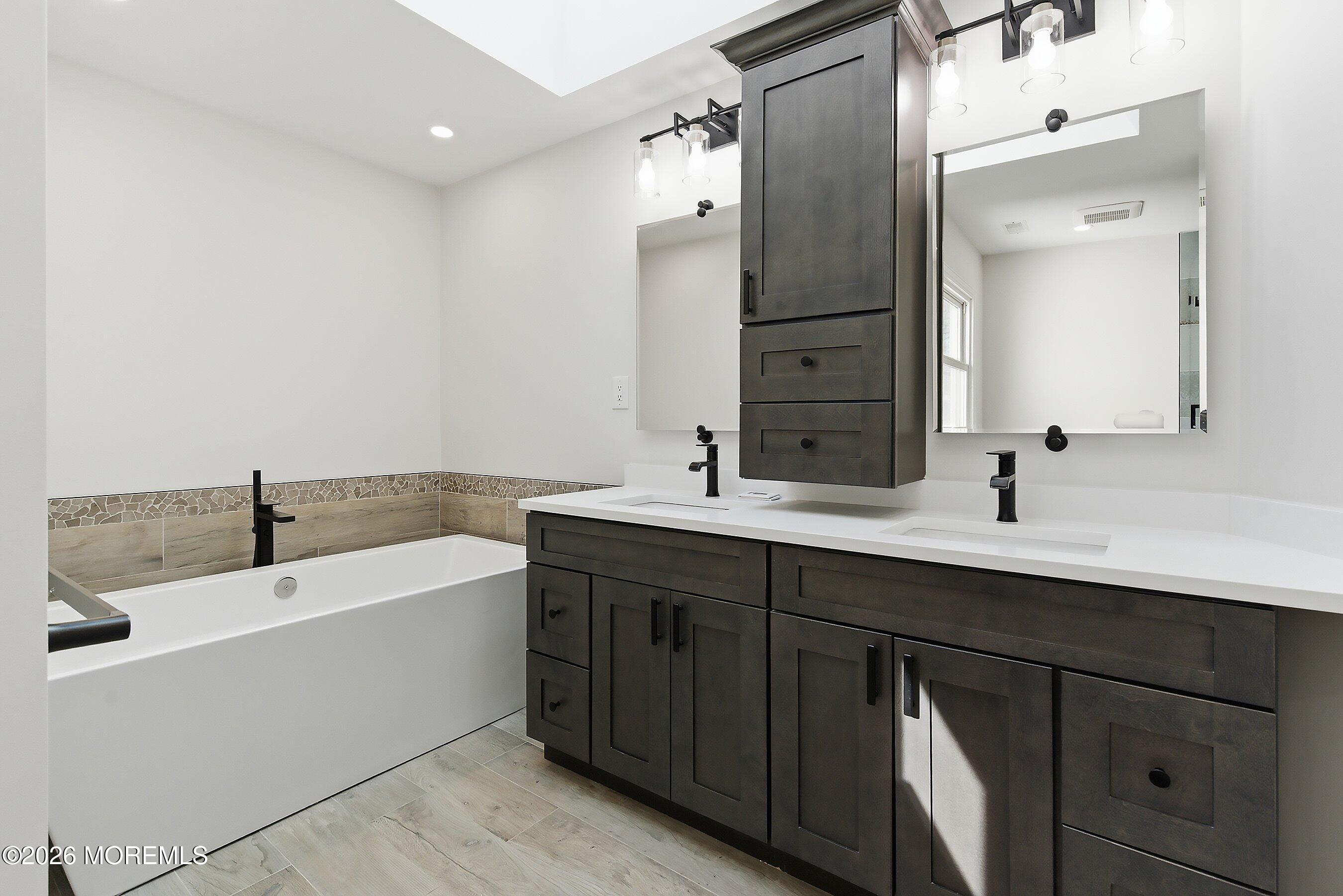 7 Shire Way Middletown, NJ 07748 - Photo 30 of 61 a bathroom with a double vanity sink and mirror