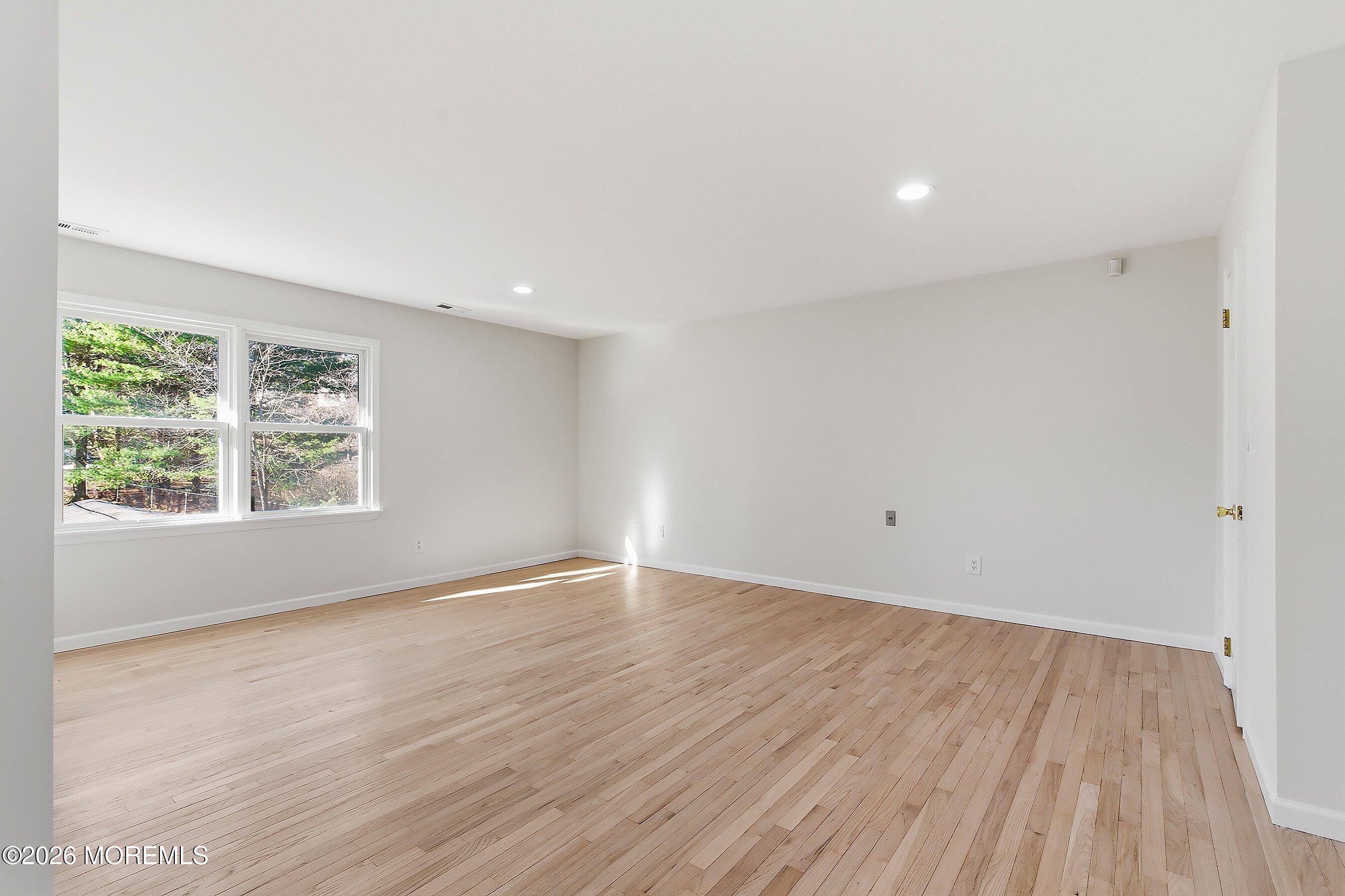 7 Shire Way Middletown, NJ 07748 - Photo 32 of 61 an empty room with wooden floor and windows