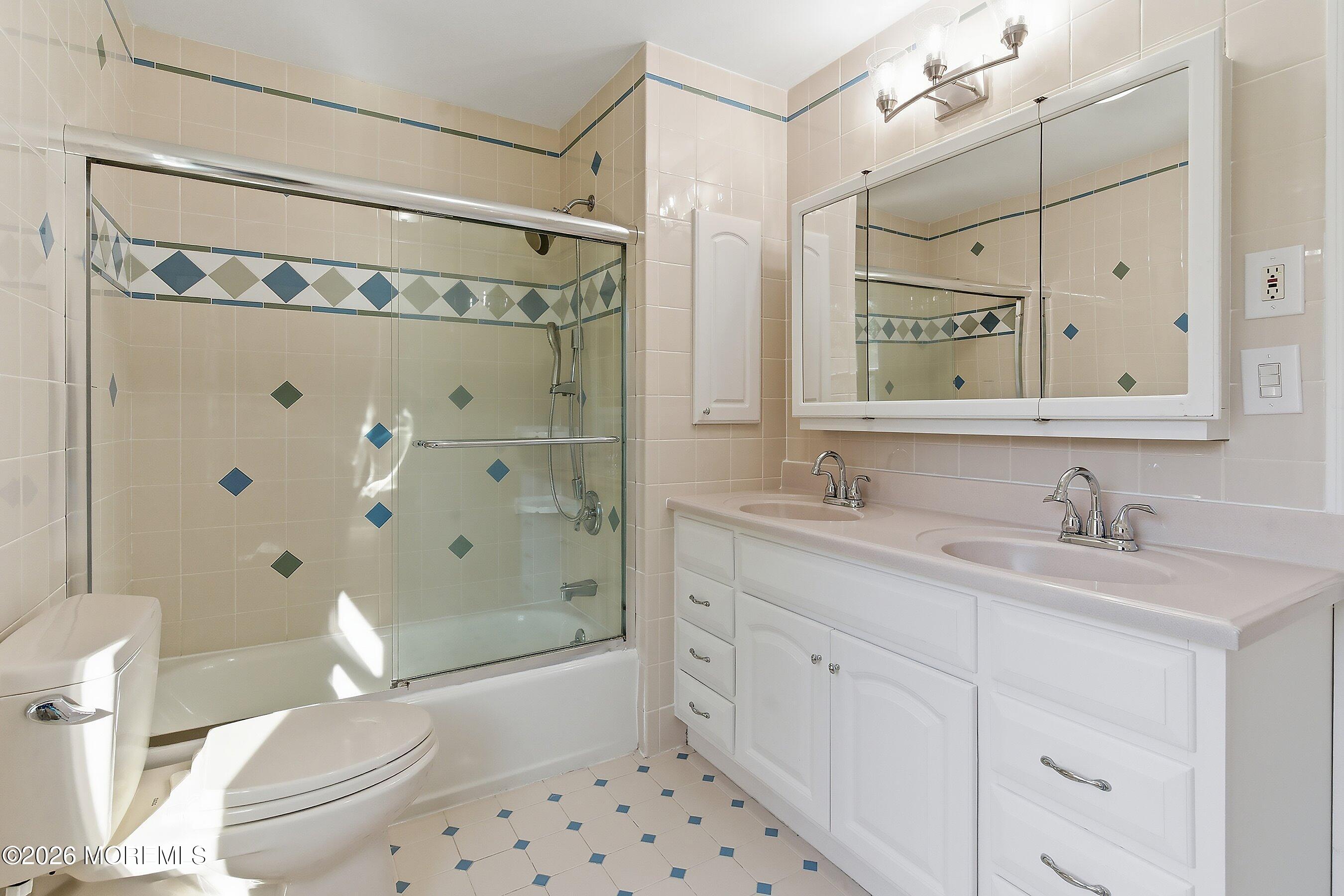 7 Shire Way Middletown, NJ 07748 - Photo 36 of 61 a bathroom with a sink a toilet a mirror a vanity and shower
