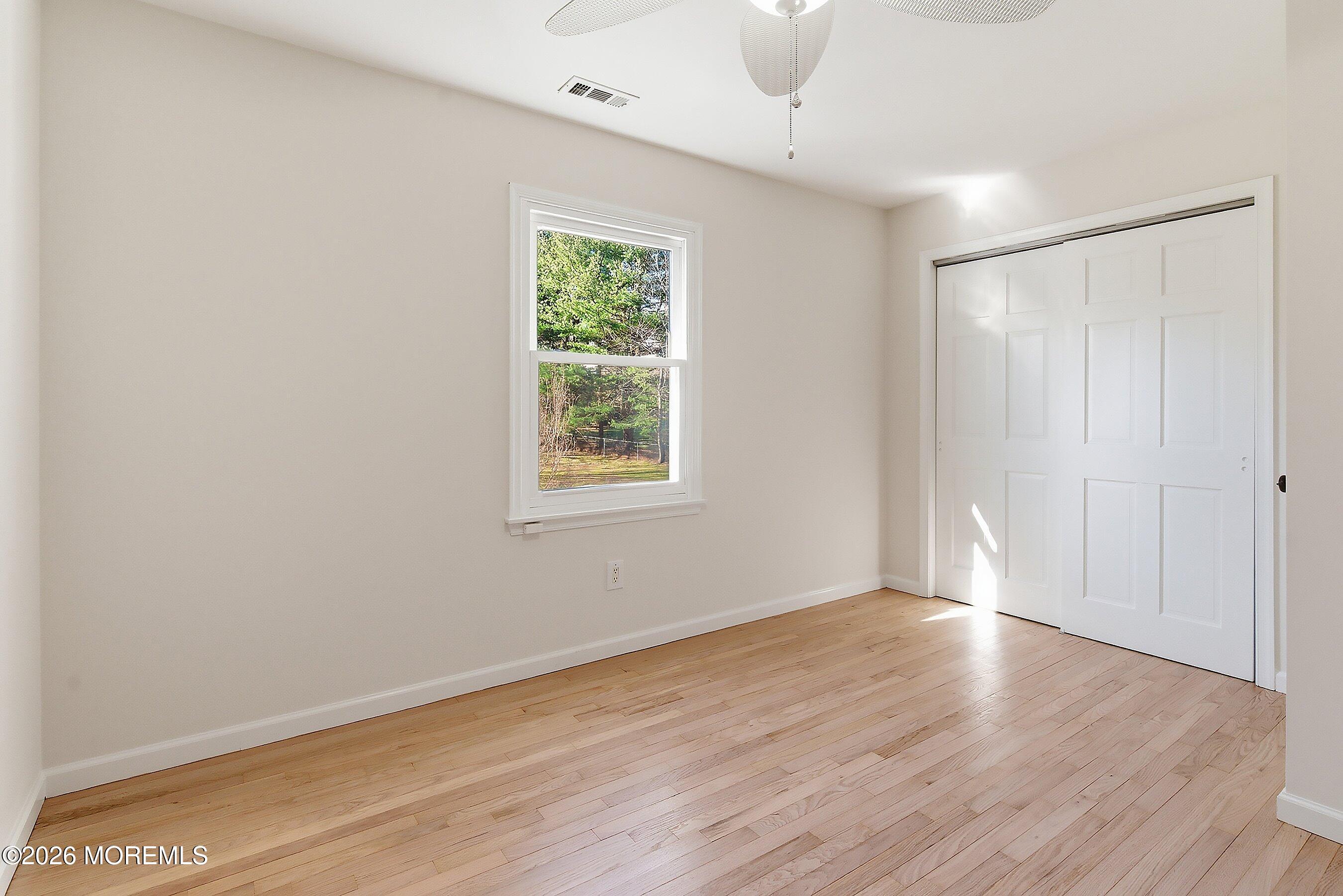 7 Shire Way Middletown, NJ 07748 - Photo 37 of 61 an empty room with wooden floor and windows