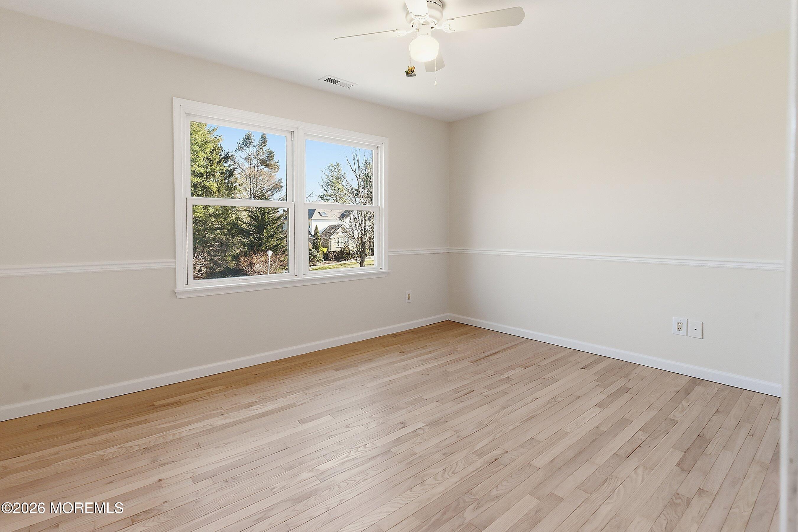 7 Shire Way Middletown, NJ 07748 - Photo 38 of 61 an empty room with wooden floor and windows