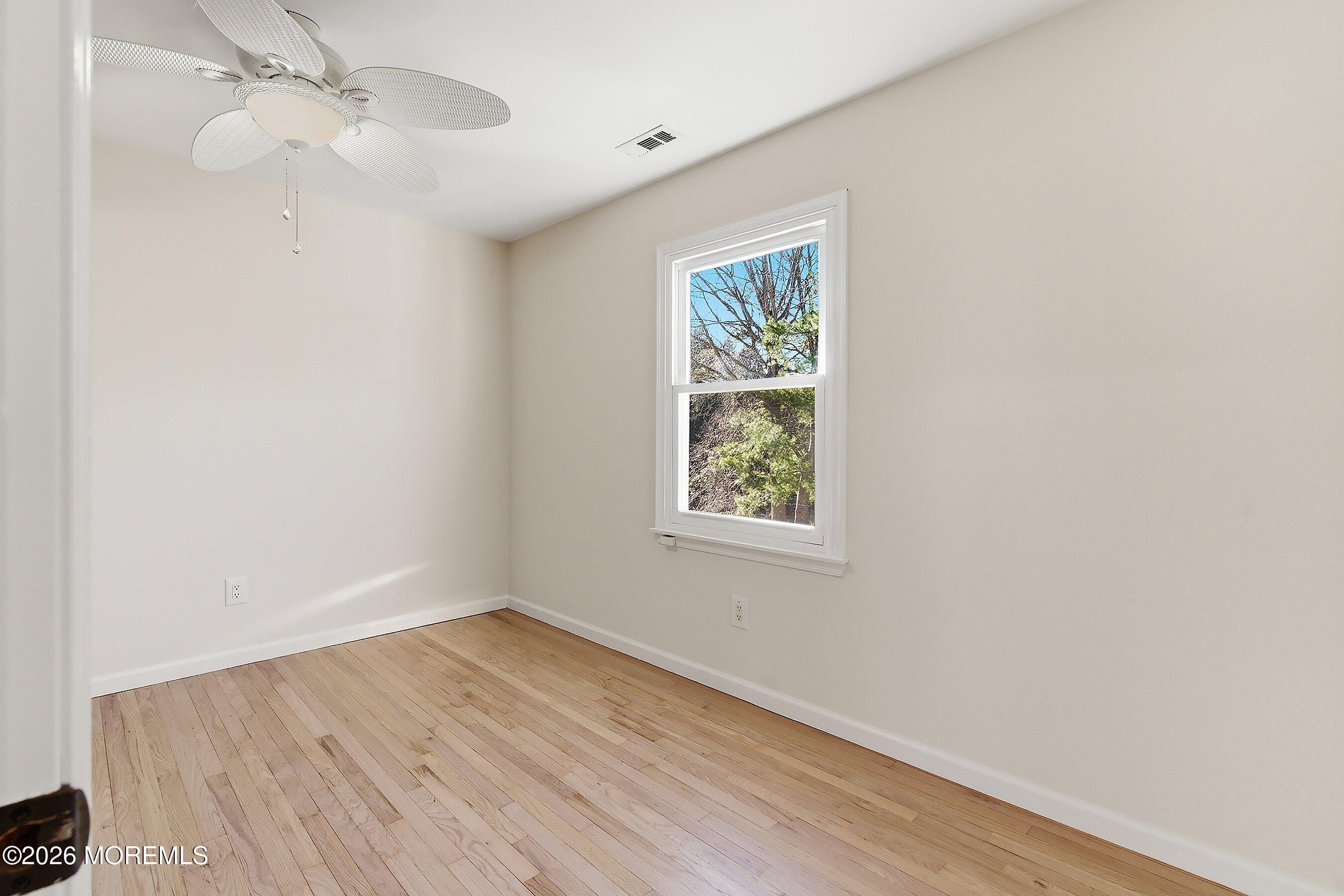 7 Shire Way Middletown, NJ 07748 - Photo 39 of 61 wooden floor in an empty room with a window