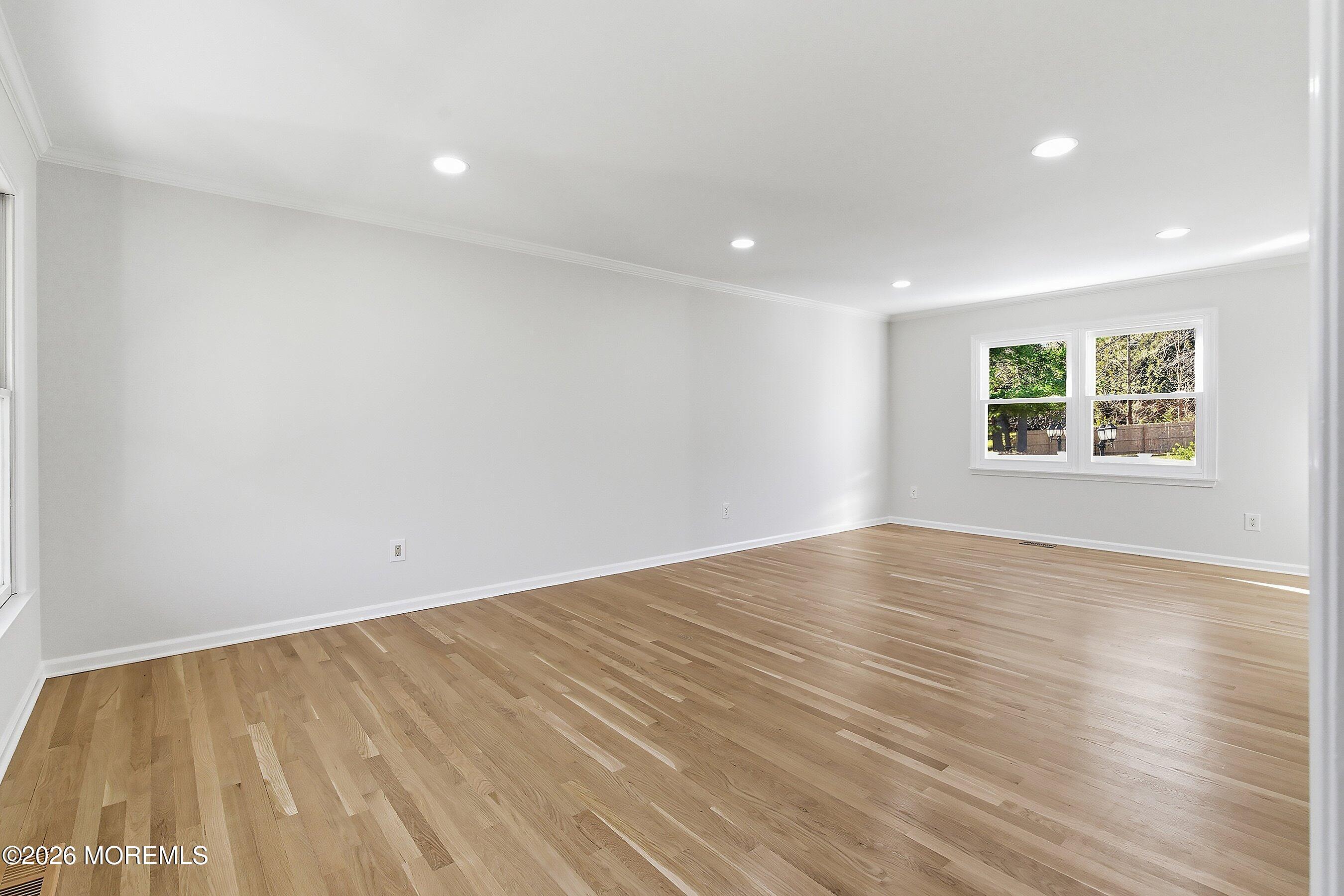 7 Shire Way Middletown, NJ 07748 - Photo 8 of 61 a view of empty room with wooden floor and fan