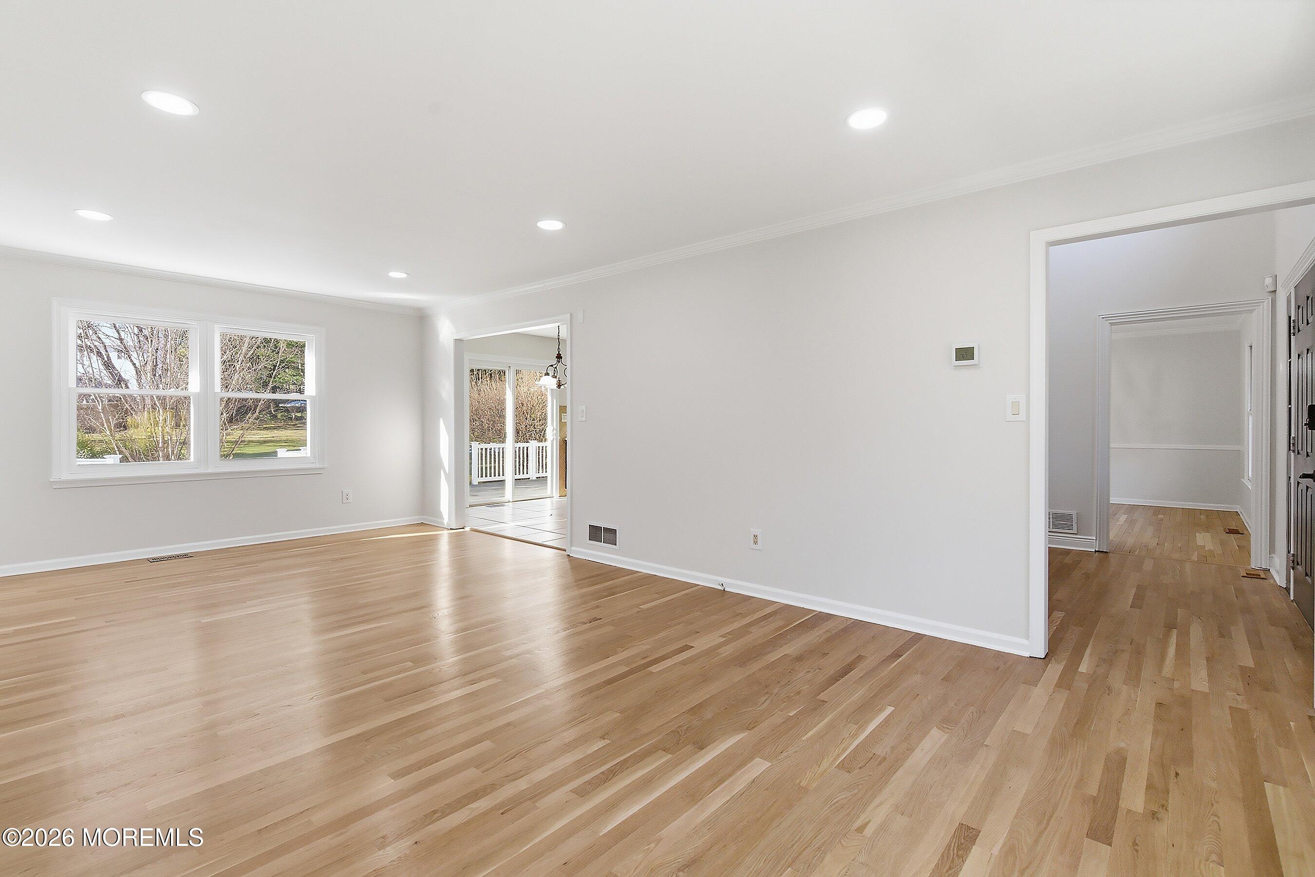 7 Shire Way Middletown, NJ 07748 - Photo 9 of 61 an empty room with wooden floor and windows