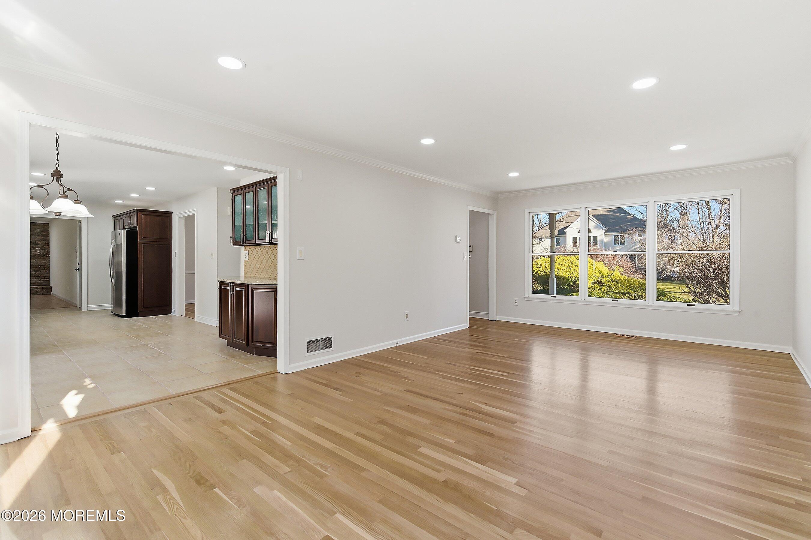 7 Shire Way Middletown, NJ 07748 - Photo 10 of 61 a view of an empty room with window and wooden floor