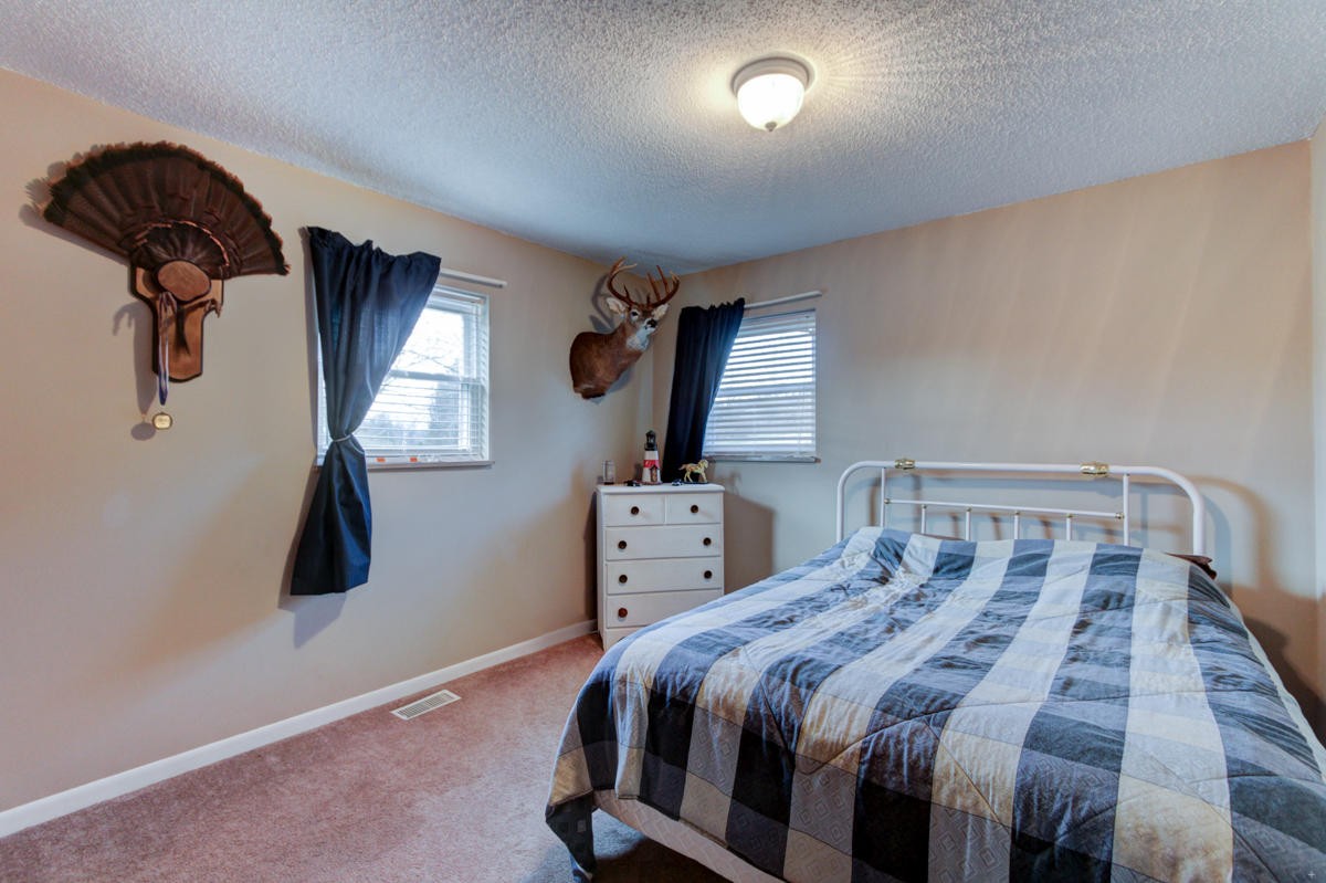 10704 Mountain Road Luttrell, TN 37779 - Photo 13 of 25 a bedroom with a bed and wooden floor