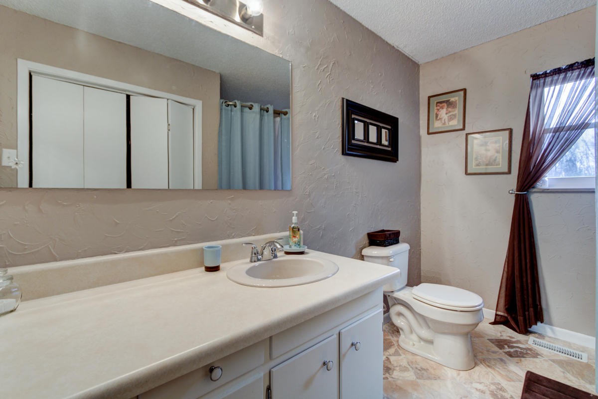 10704 Mountain Road Luttrell, TN 37779 - Photo 14 of 25 a bathroom with a sink a toilet and a mirror