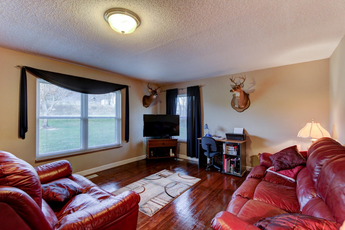 10704 Mountain Road Luttrell, TN 37779 - Photo 16 of 25 a living room with furniture a flat screen tv and a large window
