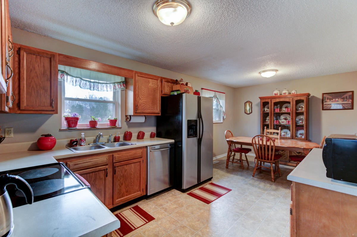 10704 Mountain Road Luttrell, TN 37779 - Photo 8 of 25 a kitchen with stainless steel appliances kitchen island granite countertop a refrigerator and a stove