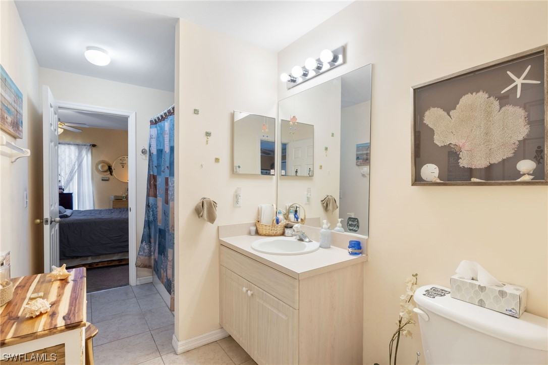 811 Abrams Boulevard Lehigh Acres, FL 33971 - Photo 14 of 22 a bathroom with a sink vanity and a mirror