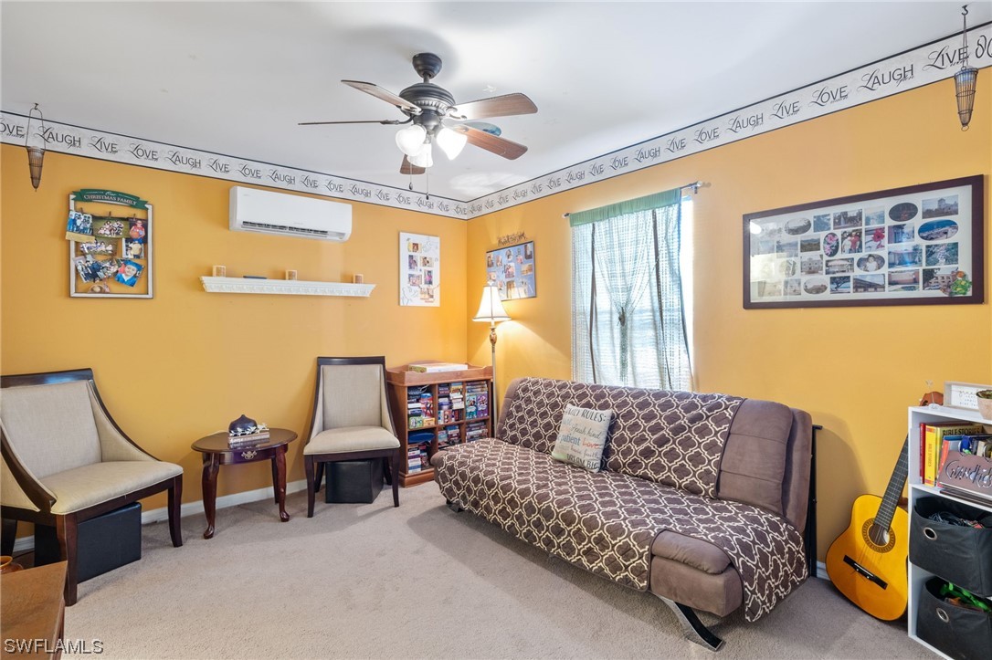 811 Abrams Boulevard Lehigh Acres, FL 33971 - Photo 15 of 22 a living room with furniture and a large window