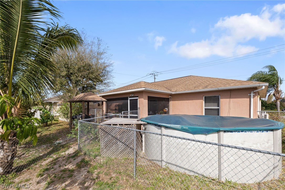 811 Abrams Boulevard Lehigh Acres, FL 33971 - Photo 17 of 22 a front view of a house with yard