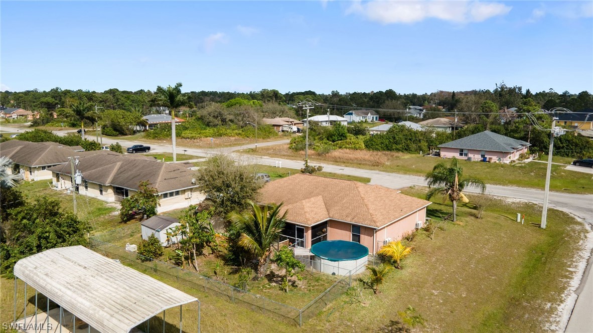 811 Abrams Boulevard Lehigh Acres, FL 33971 - Photo 18 of 22 a view of a swimming pool with a table and chairs