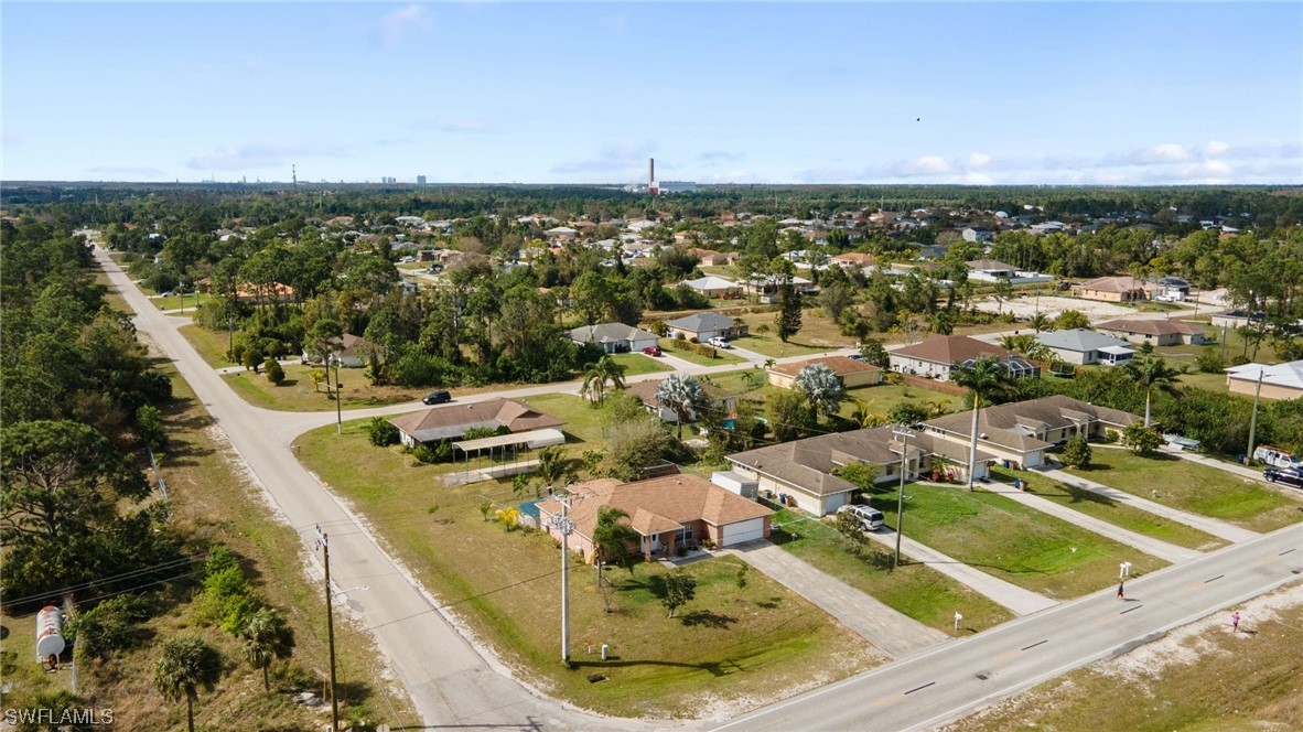 811 Abrams Boulevard Lehigh Acres, FL 33971 - Photo 21 of 22 an aerial view of a house with a swimming pool