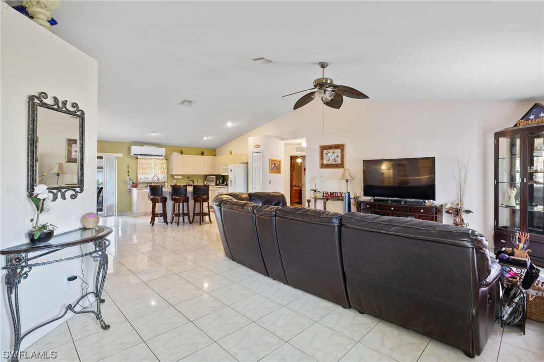 811 Abrams Boulevard Lehigh Acres, FL 33971 - Photo 3 of 22 a living room with furniture and a flat screen tv