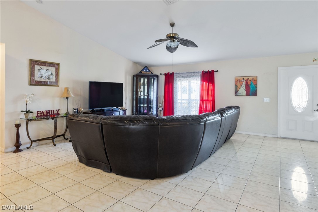 811 Abrams Boulevard Lehigh Acres, FL 33971 - Photo 4 of 22 a living room with furniture and a flat screen tv