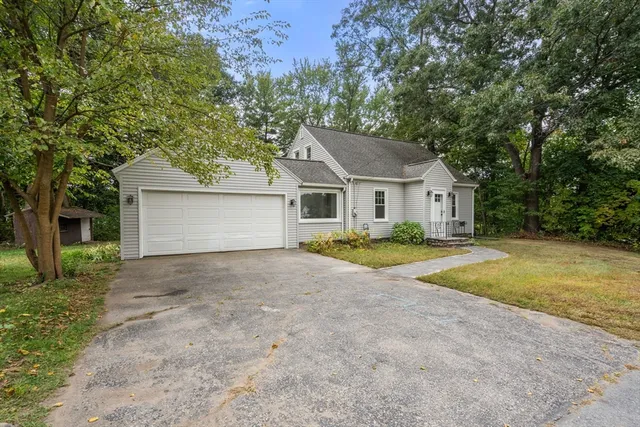 a view of backyard of house with green space