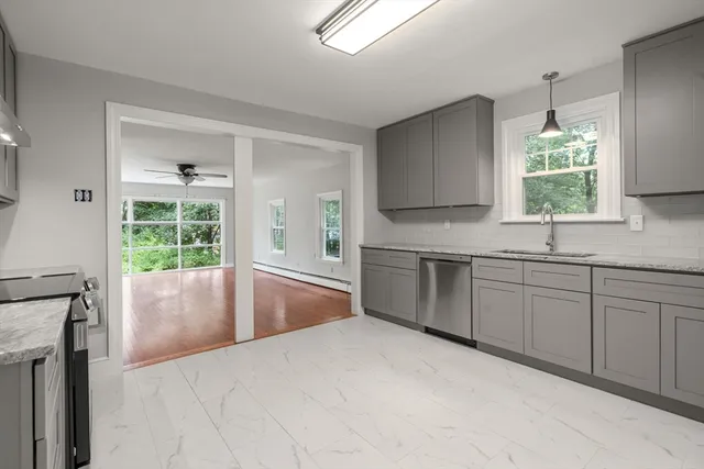 a kitchen with a sink window and cabinets