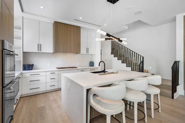 a kitchen with a stove a table and chairs