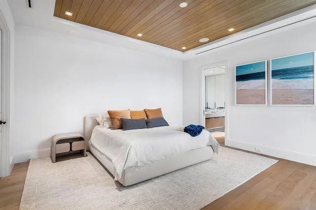 a bedroom with bed and a large window