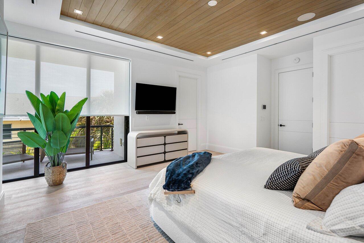 514 Northeast 7th Avenue Delray Beach, FL 33483 - Photo 22 of 51 a bedroom with a bed and a flat screen tv