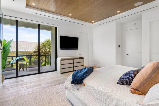 a bedroom with a bed and large window