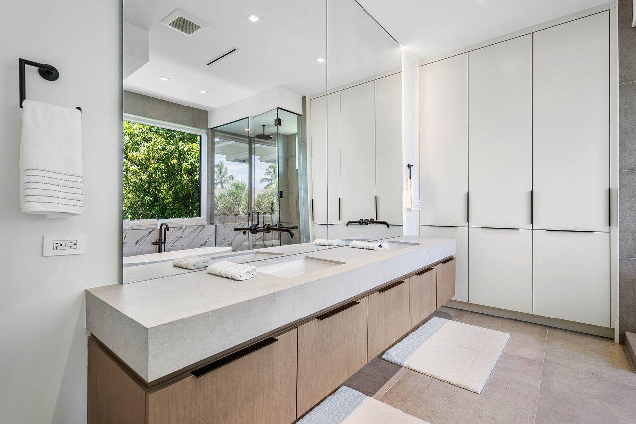 514 Northeast 7th Avenue Delray Beach, FL 33483 - Photo 28 of 51 a bathroom with a sink and mirror with a shower