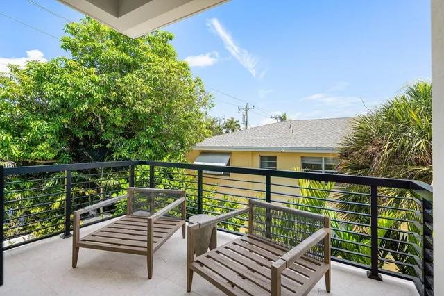 a view of a roof deck with wooden fence and bench