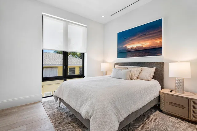 a bedroom with a bed and a painting on the wall