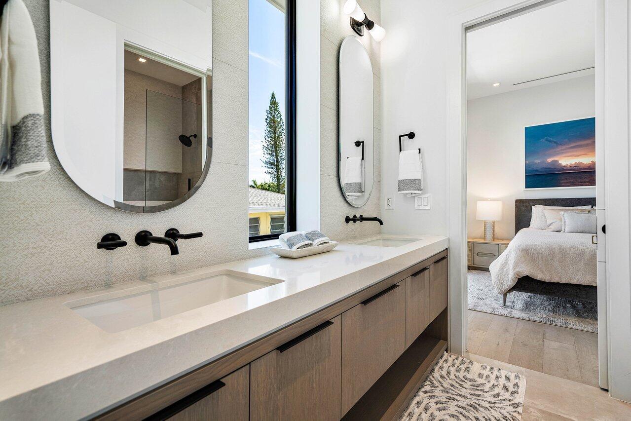 514 Northeast 7th Avenue Delray Beach, FL 33483 - Photo 39 of 51 a en suite bathroom with a double vanity sink and a mirror