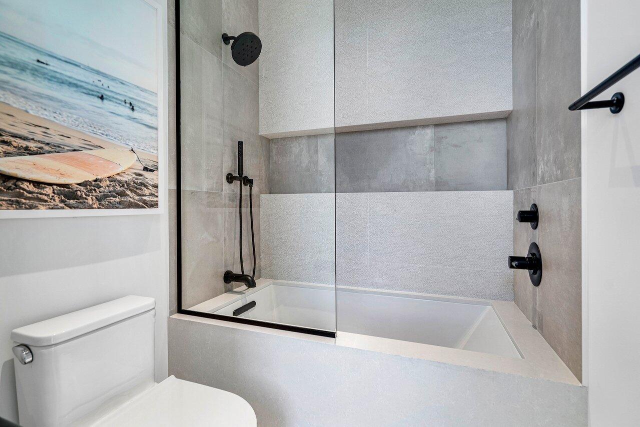 514 Northeast 7th Avenue Delray Beach, FL 33483 - Photo 40 of 51 a bathroom with a shower and a toilet