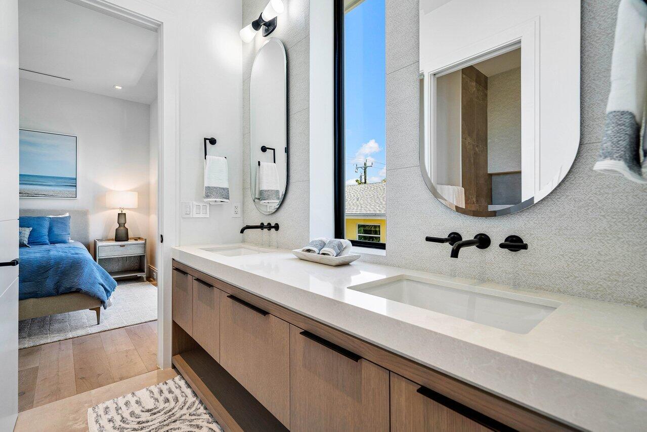 514 Northeast 7th Avenue Delray Beach, FL 33483 - Photo 41 of 51 a spacious bathroom with a sink double vanity and a mirror