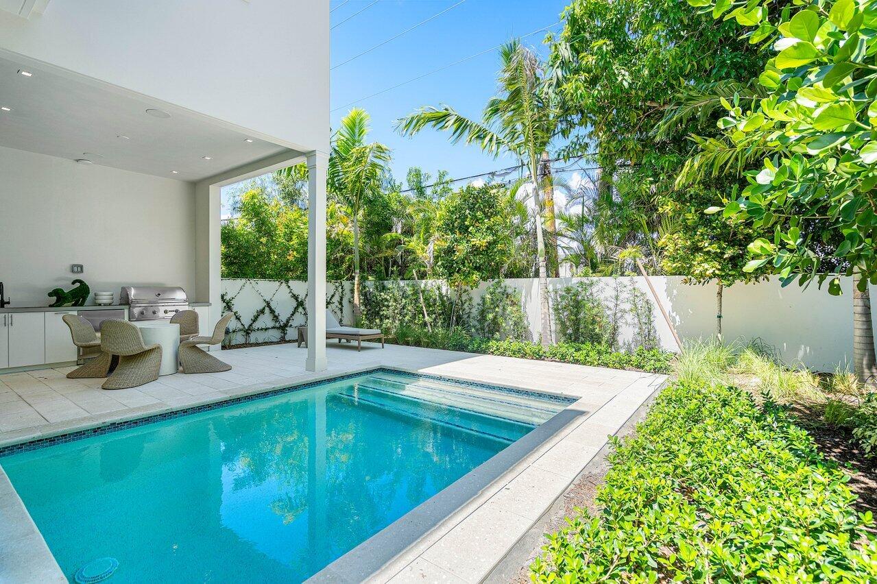 514 Northeast 7th Avenue Delray Beach, FL 33483 - Photo 46 of 51 a view of a swimming pool with a patio