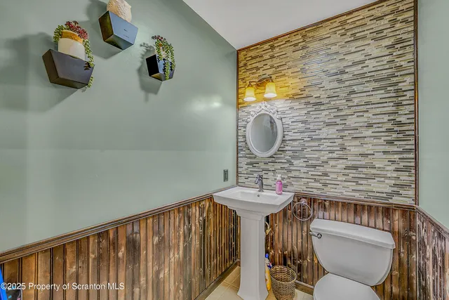 a bathroom with a sink mirror and toilet