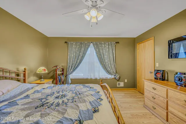 a bedroom with a bed and a dresser