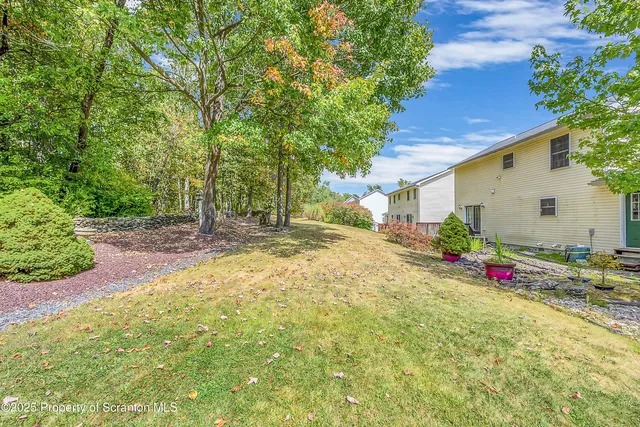 a backyard of a house with flower plants