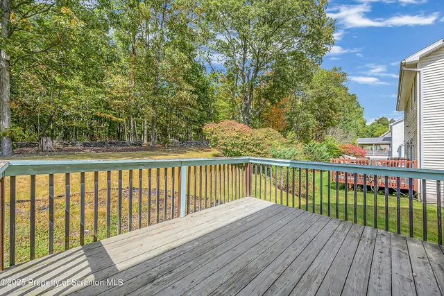 a view of wooden deck and a yard