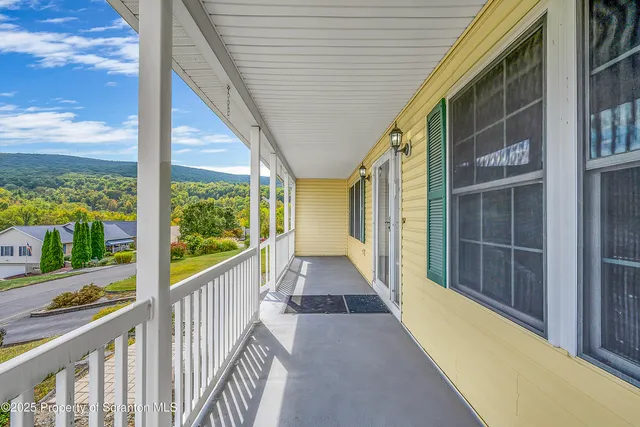 a view of balcony with floor to ceiling windows with wooden floor