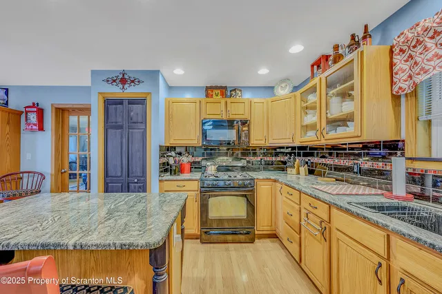 a kitchen with stainless steel appliances granite countertop a sink and cabinets