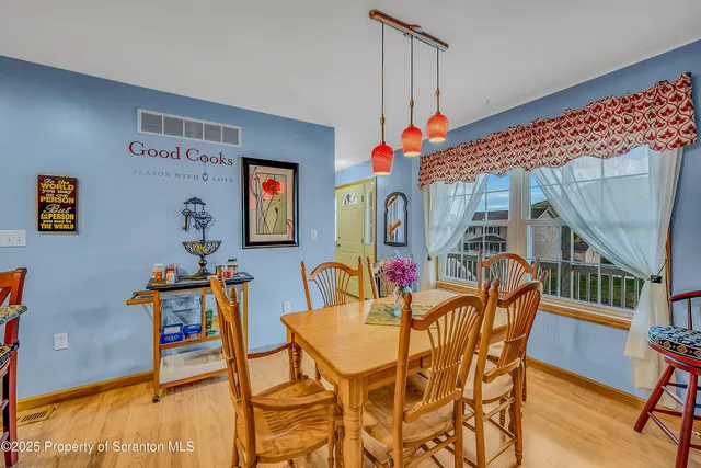 a dining room with furniture and wooden floor