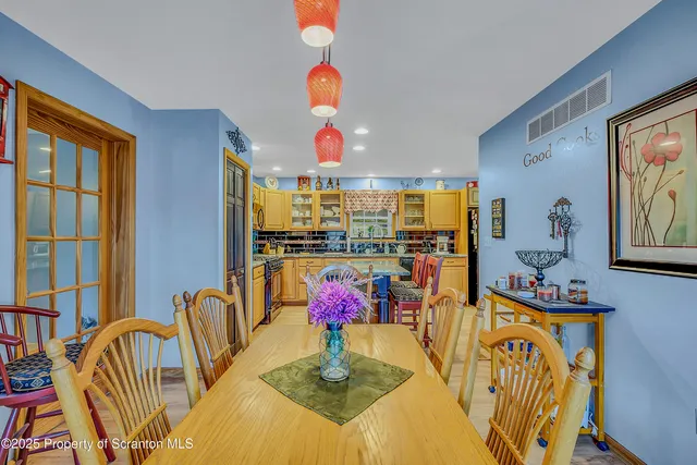 a living room with dining room and kitchen view