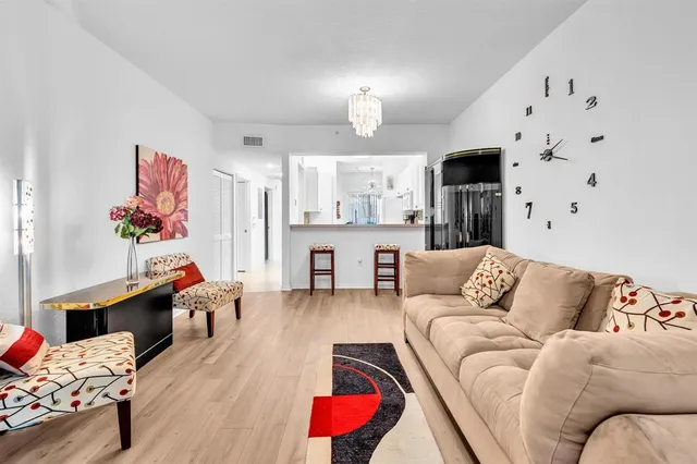 a spacious bathroom with a granite countertop sink a toilet a mirror and shower