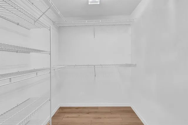 a front view of a house with a garden and trees