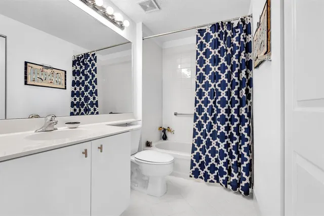 a view of a swimming pool with a lawn chairs under palm trees