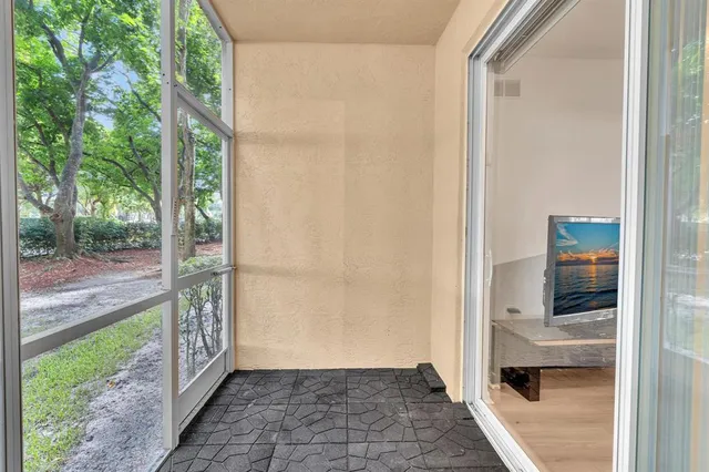 a living room with lots of furniture and view of kitchen