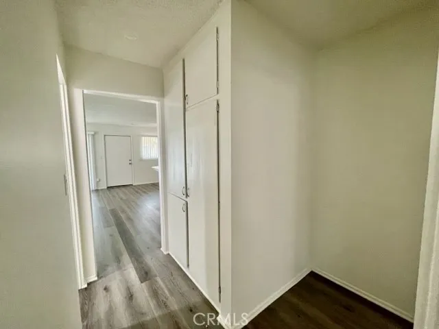 a view of a hallway with wooden floor