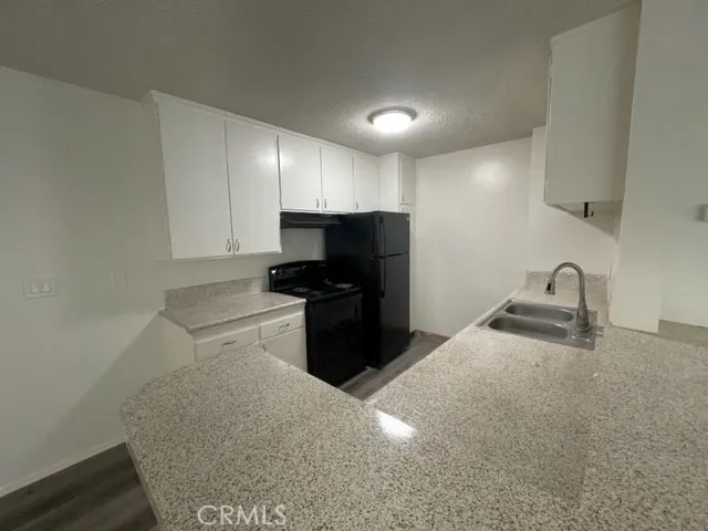 a kitchen with a sink a stove and refrigerator