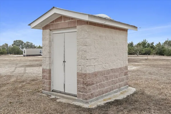 an aerial view of a house with a yard and lake view